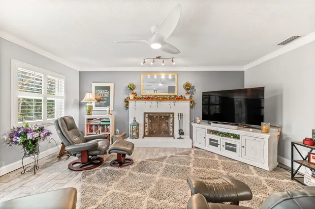a living room with furniture a fireplace and a flat screen tv