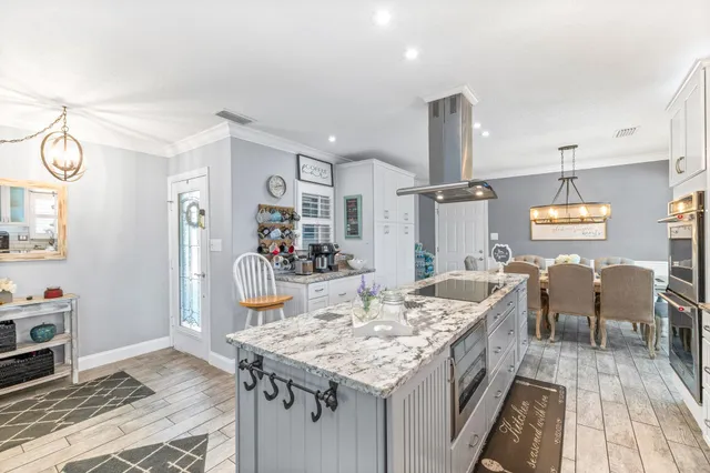 a view of kitchen island with granite countertop cabinets