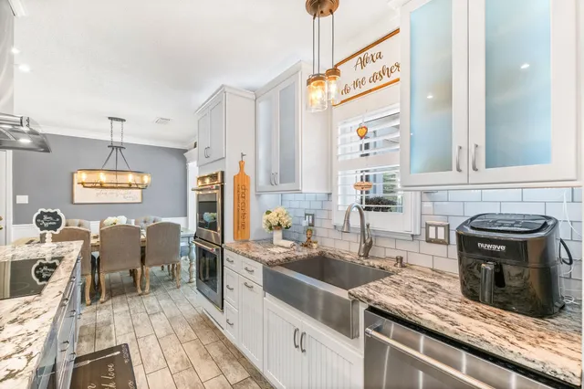 a kitchen with granite countertop a sink and a window