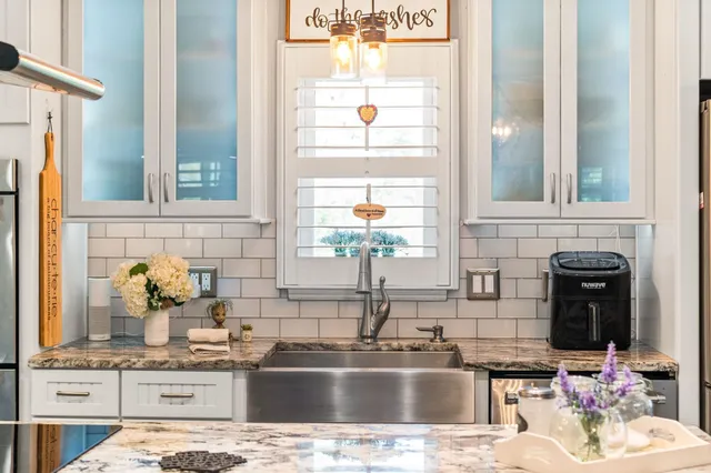a table with a clock on a table and a window