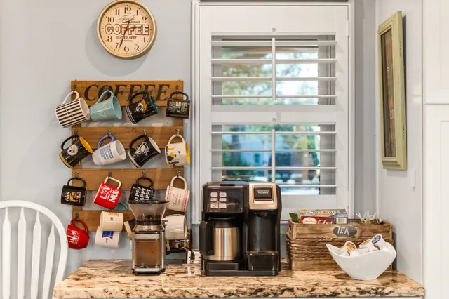 a kitchen with granite countertop a sink and a white wooden cabinets