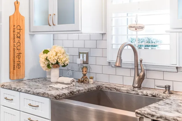 a kitchen with stainless steel appliances granite countertop a sink stove and cabinets