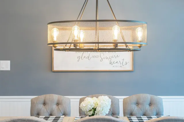 a living room with fireplace furniture and a chandelier