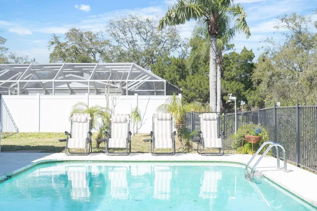 a view of a swimming pool with a yard