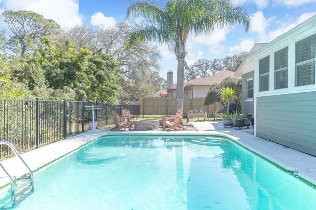 a view of a house with swimming pool and sitting area