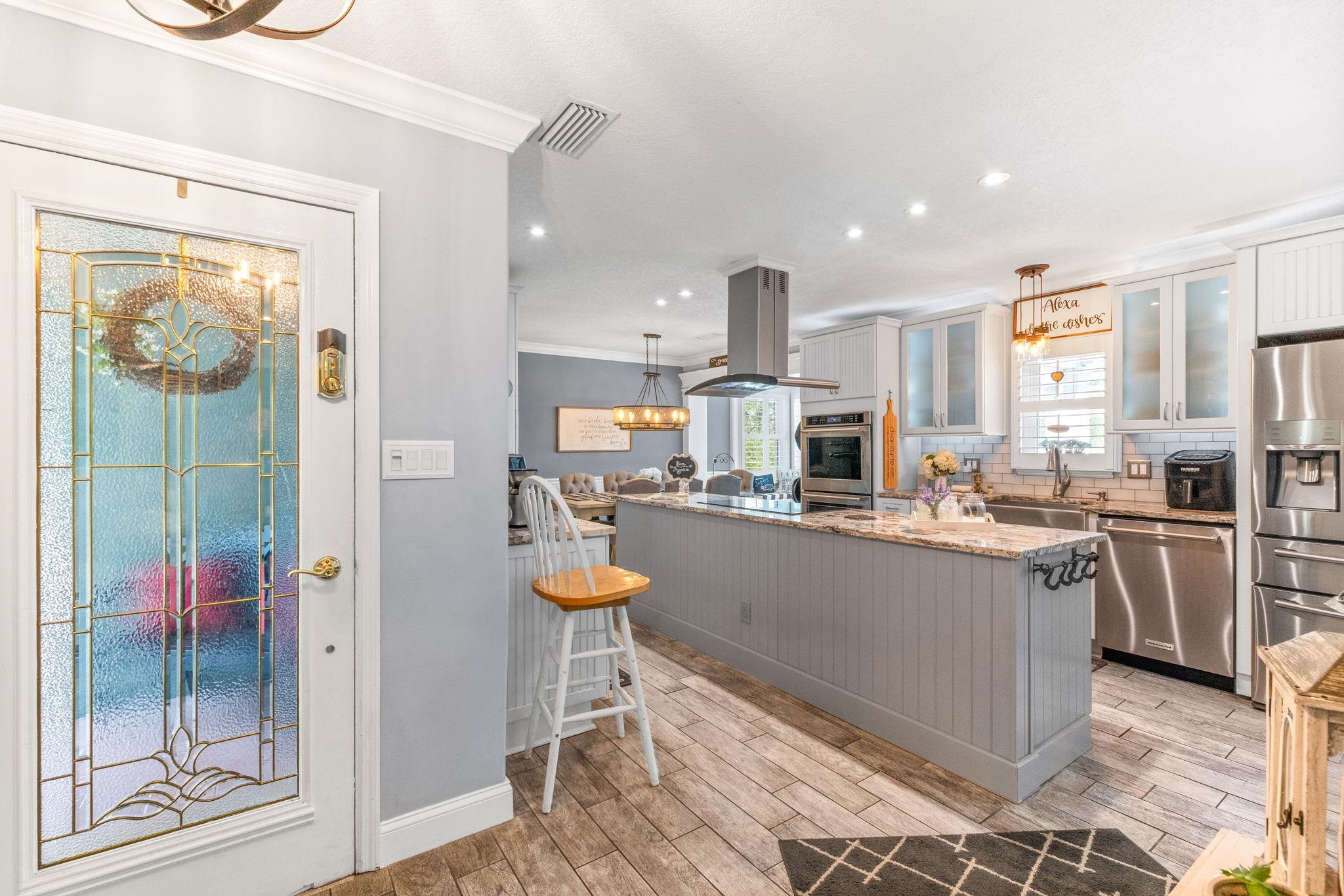 5312 Riverview Drive St. Augustine, FL 32080 - Photo 9 of 54 a kitchen with stainless steel appliances kitchen island granite countertop a table and chairs in it