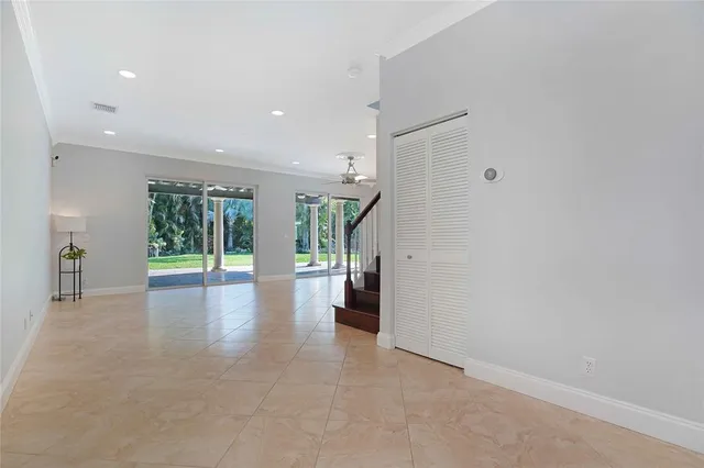 a view of an empty room with a windows and wooden door