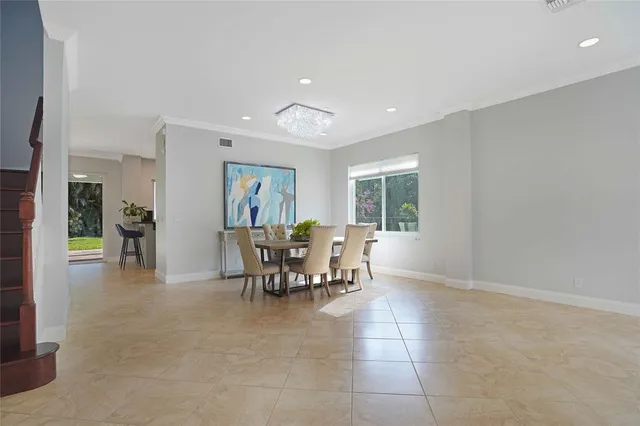 a view of a dining room with furniture and a potted plant