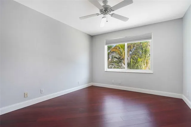 a bathroom with a granite countertop sink a large mirror a toilet and a bathtub