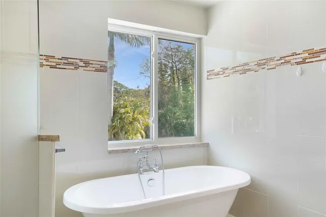 a bedroom with a large bed and a large window