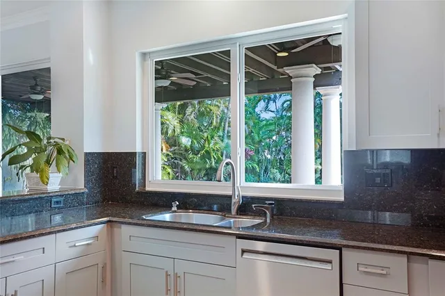 a kitchen with a sink and large window