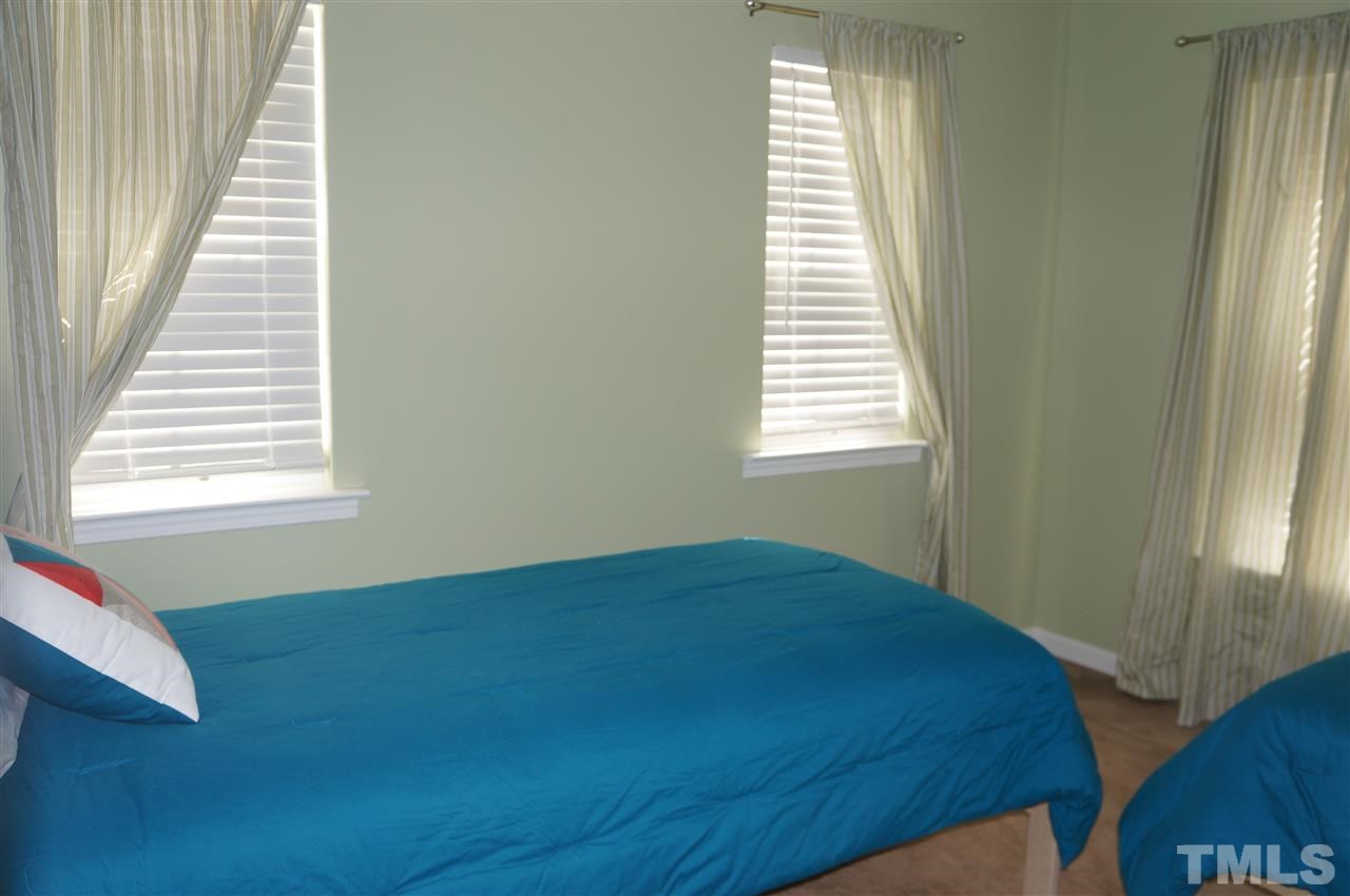 177 Ryder Cup Circle Raleigh, NC 27603 - Photo 15 of 25 The room is L-like shaped and perfect for your home office, 2nd floor TV room, or as these homeowners are doing, a cute guest suite!