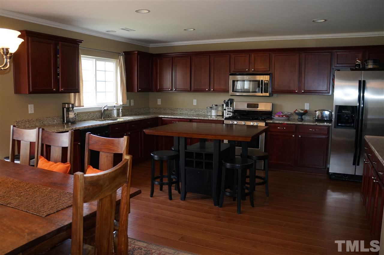 177 Ryder Cup Circle Raleigh, NC 27603 - Photo 7 of 25 Large updated kitchen includes granite countertops & sink, cherry cabinets, stainless steel appliances, gas range, pantry & more!