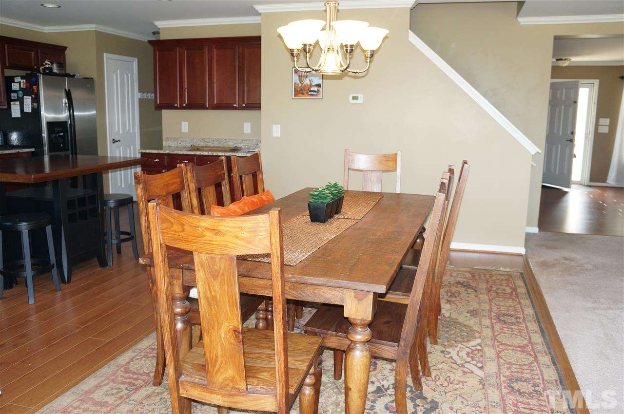 177 Ryder Cup Circle Raleigh, NC 27603 - Photo 24 of 25 Here's the "sought after" open floor plan today's homebuyers desire! The kitchen, dining area and family room create a wondering living area...truly the heart of any family!