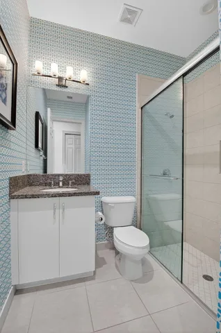 a kitchen with a sink stainless steel appliances and white cabinets