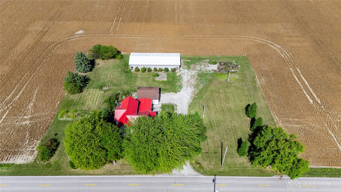 7404 Grubbs-Rex Road Arcanum, OH 45304 - Photo 33 of 40 This captivating aerial view captures a vibrant home amidst verdant landscapes and expansive fields.