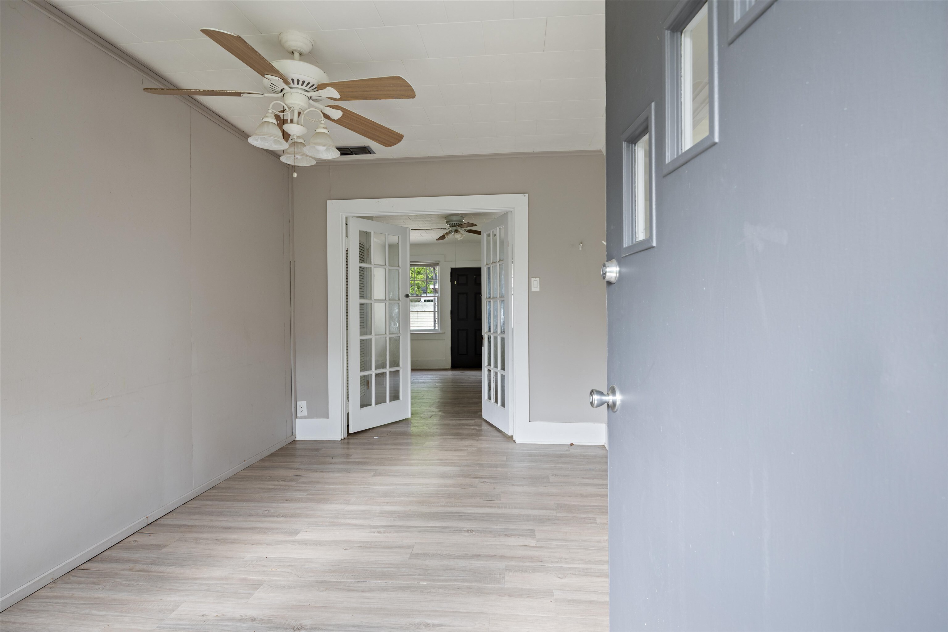 112 South Juniper Street Foley, AL 36535 - Photo 47 of 64 Empty room with a ceiling fan and light wood-style flooring