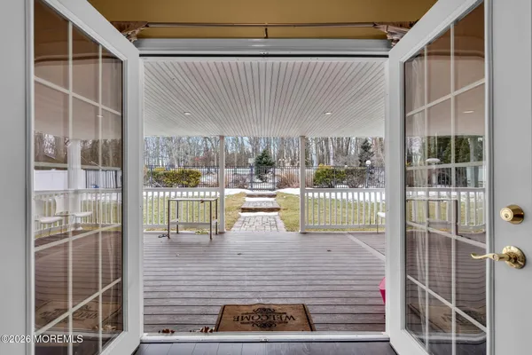 a kitchen with stainless steel appliances granite countertop a refrigerator a stove top oven a sink dishwasher and white cabinets with wooden floor