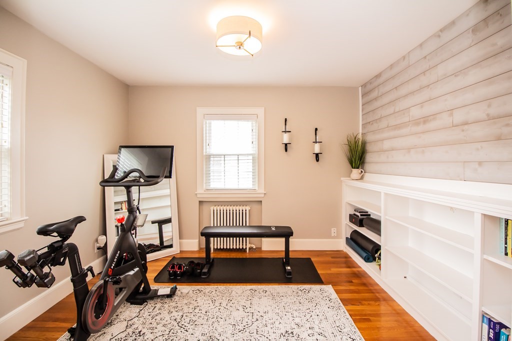 66 Howitt Road Boston, MA 02132 - Photo 14 of 24 a bedroom with furniture and a window