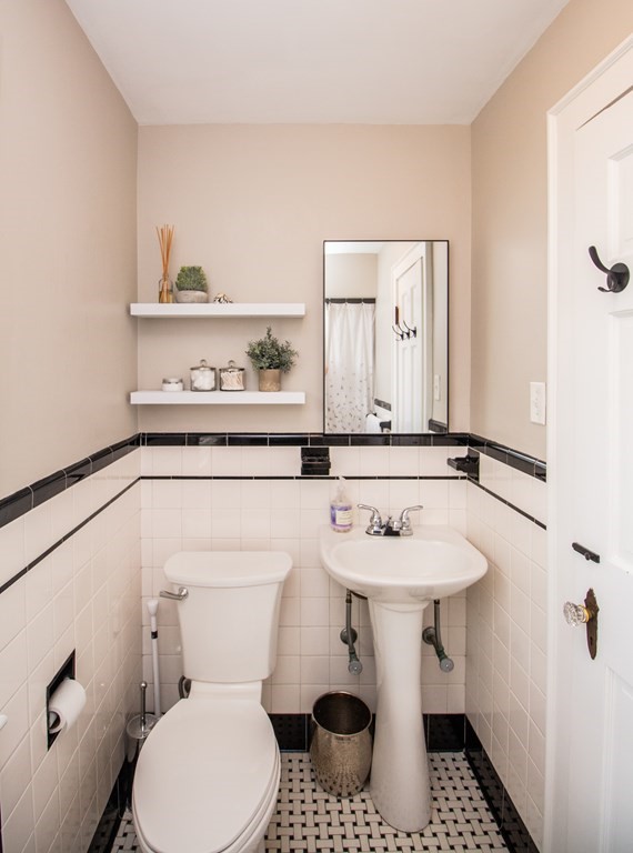 66 Howitt Road Boston, MA 02132 - Photo 16 of 24 a bathroom with a toilet sink and mirror
