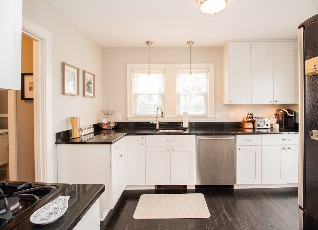 66 Howitt Road Boston, MA 02132 - Photo 2 of 24 a kitchen with a sink and a stove top oven