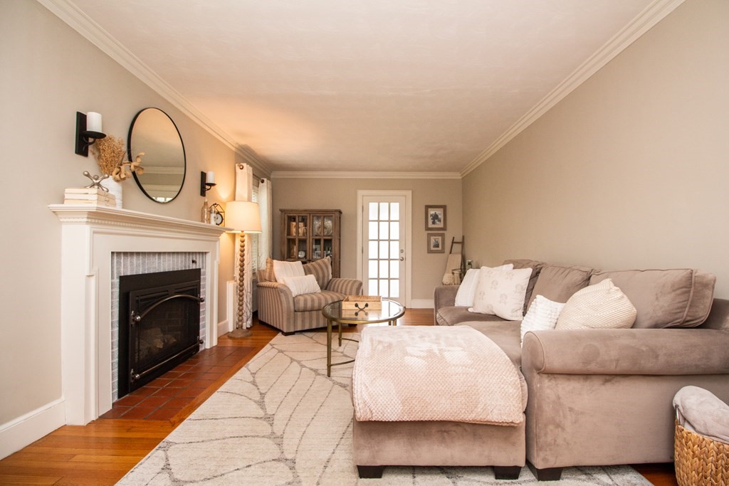66 Howitt Road Boston, MA 02132 - Photo 5 of 24 a living room with furniture a fireplace and a flat screen tv