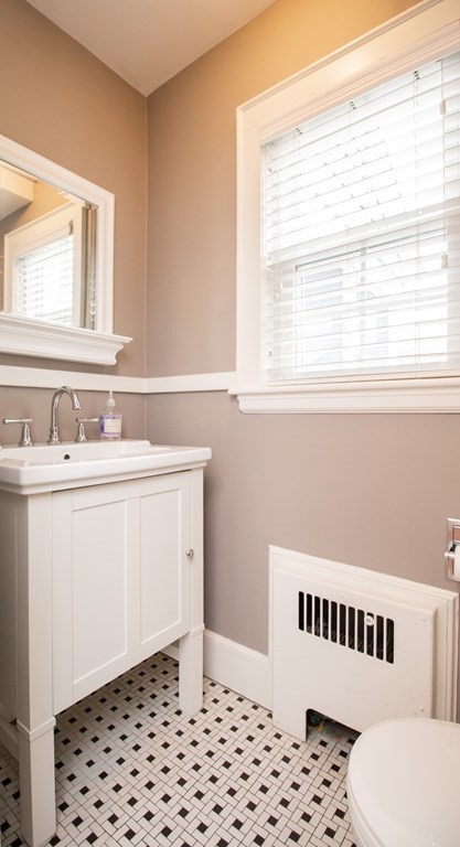 66 Howitt Road Boston, MA 02132 - Photo 8 of 24 a bathroom with a sink a mirror and a toilet