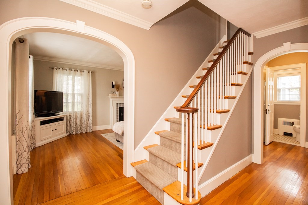 66 Howitt Road Boston, MA 02132 - Photo 9 of 24 a view of a hallway with wooden floor and staircase with wooden floor