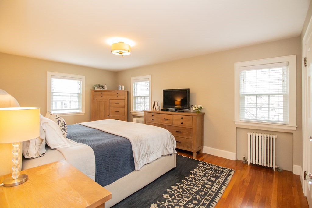 66 Howitt Road Boston, MA 02132 - Photo 10 of 24 a bedroom with a bed and wooden floor