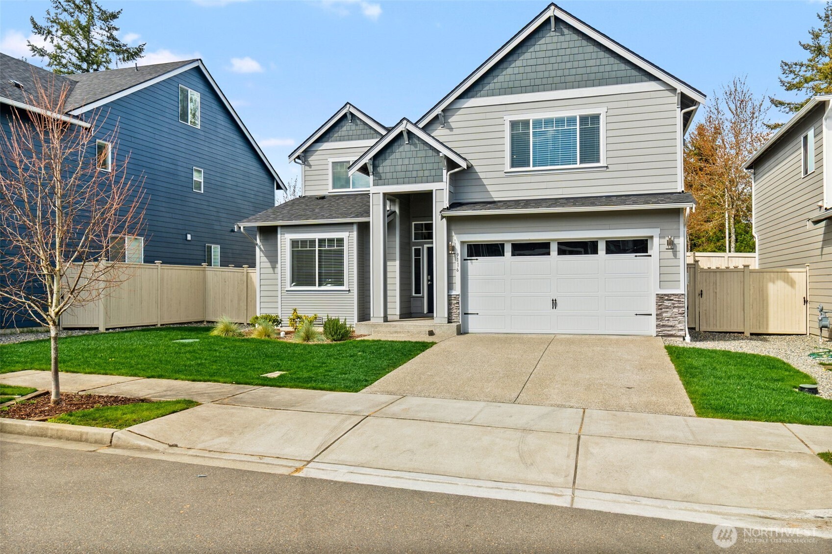 a front view of a house with a yard and a garage