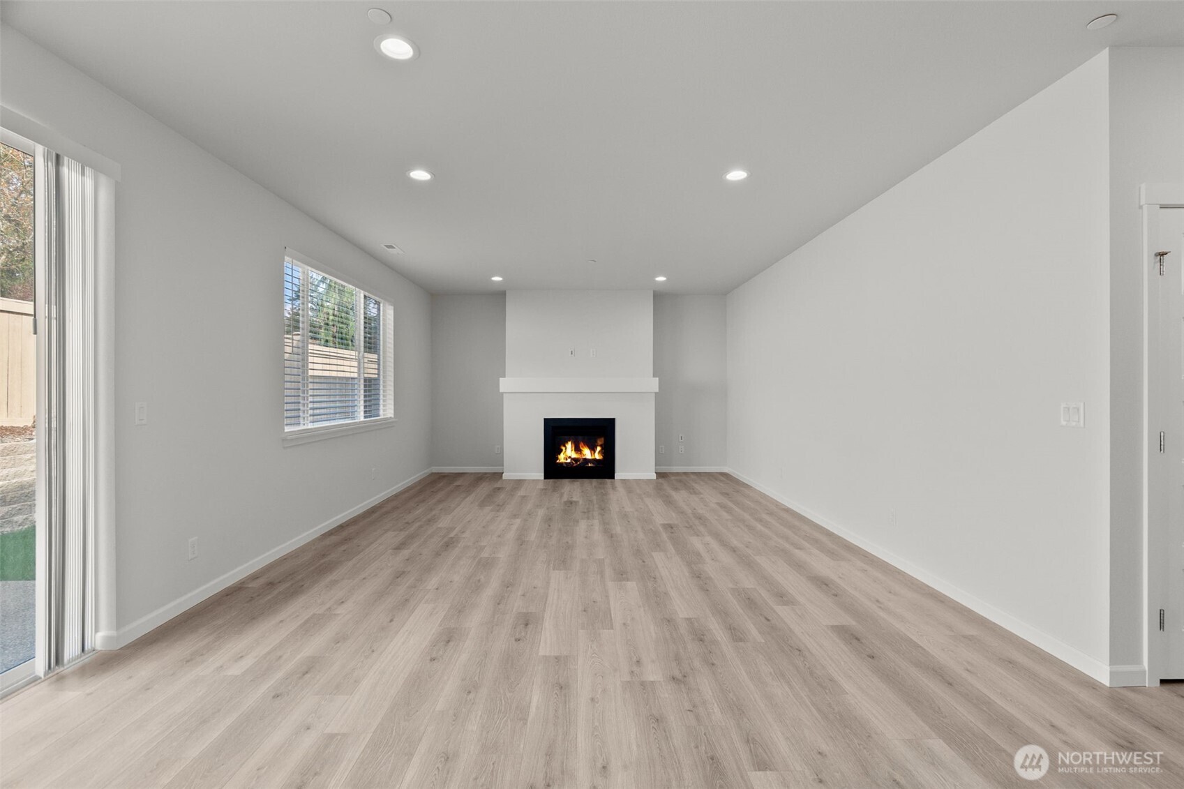 9116 Carlos Way Northeast Lacey, WA 98516 - Photo 13 of 34 a view of an empty room with a fireplace and a window