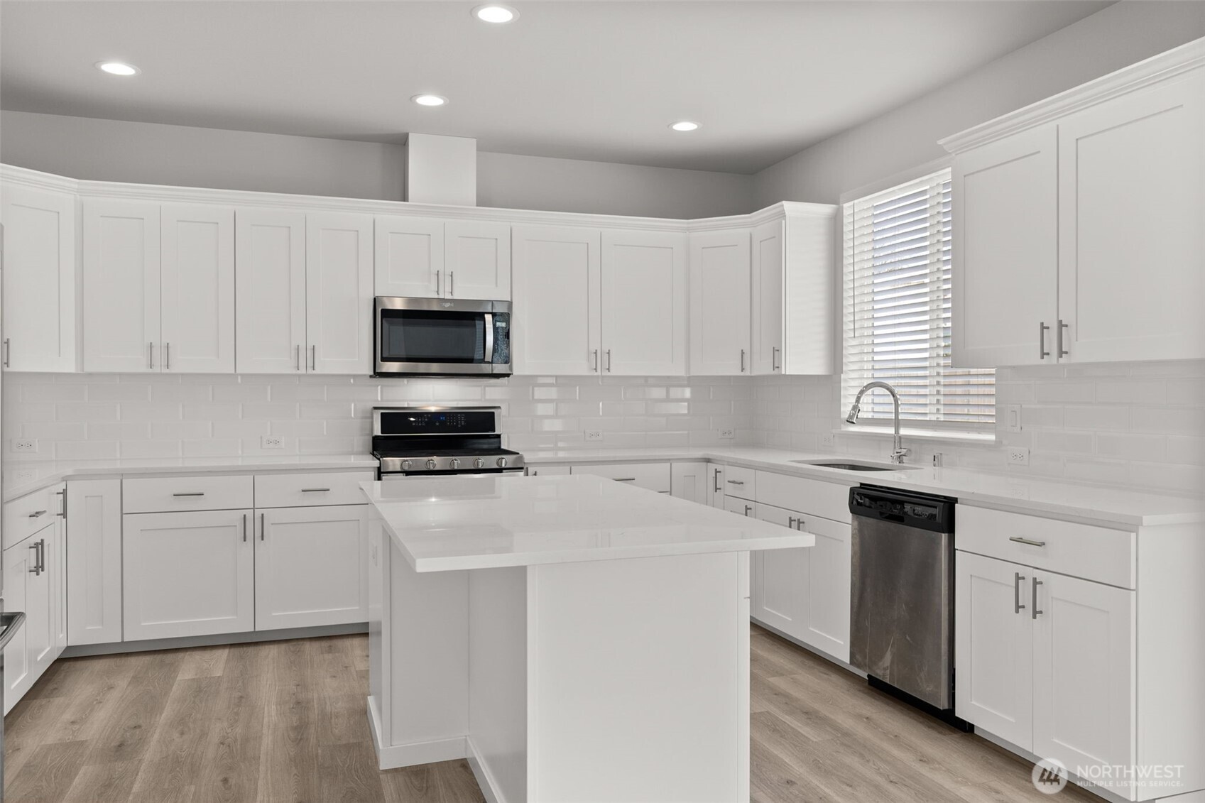 9116 Carlos Way Northeast Lacey, WA 98516 - Photo 16 of 34 a kitchen with granite countertop white cabinets and black stainless steel appliances