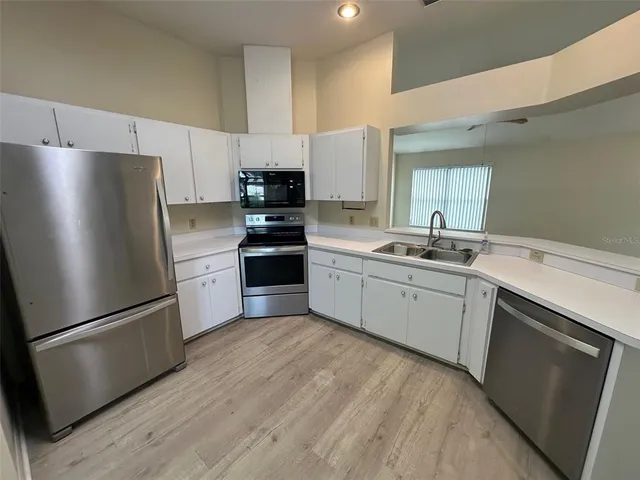 a kitchen with a refrigerator sink and microwave