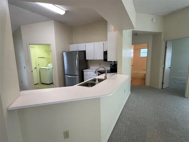 a kitchen with refrigerator and window