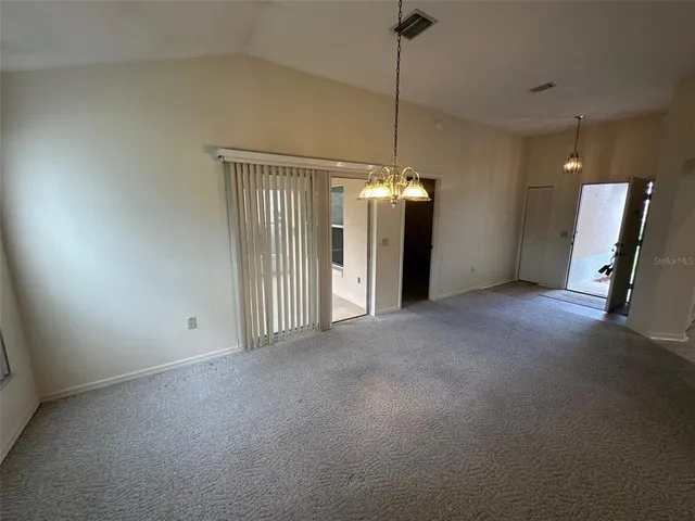 a view of a hallway with a chandelier