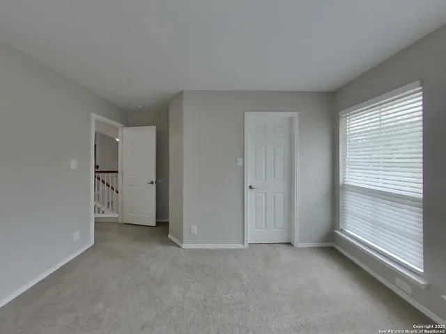 a view of an empty room and a window