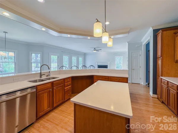 a kitchen with kitchen island a sink stainless steel appliances and cabinets