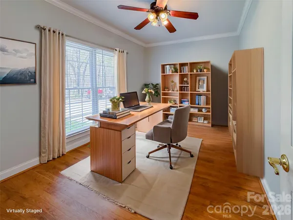 a work room with furniture and a potted plant