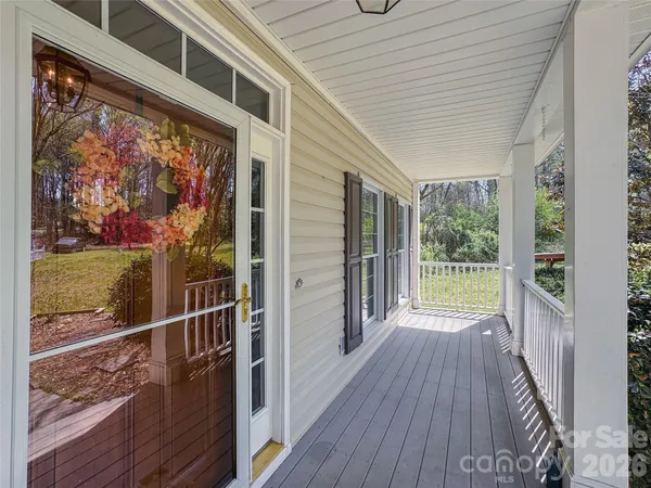 a view of a balcony with wooden floor and fence