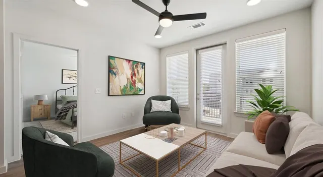 a living room with furniture and wooden floor