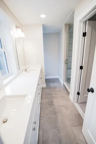 a bathroom with a sink a mirror and a vanity