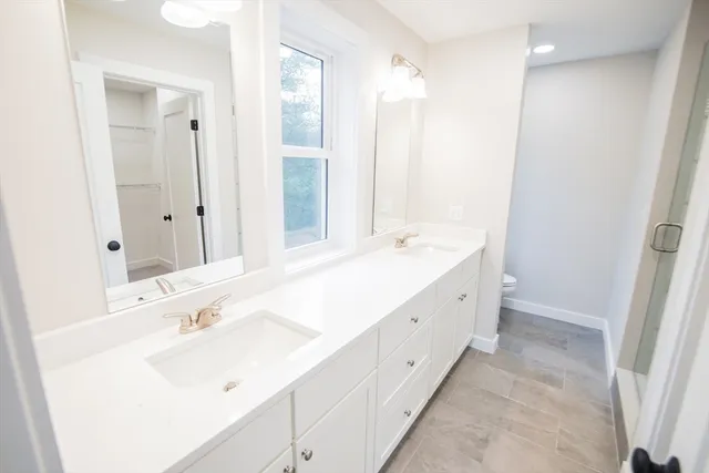 a spacious bathroom with a double vanity sink mirror and