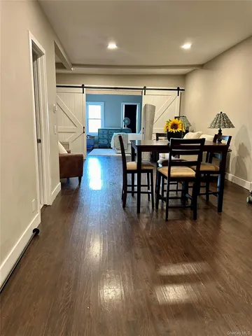 a view of a dining room with furniture and wooden floor