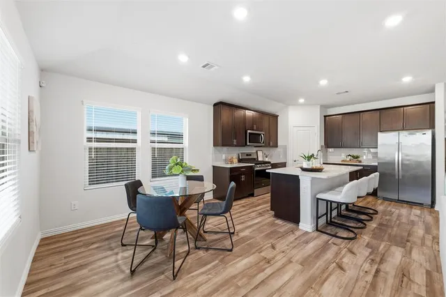 a view of a dining room with furniture window and wooden floor