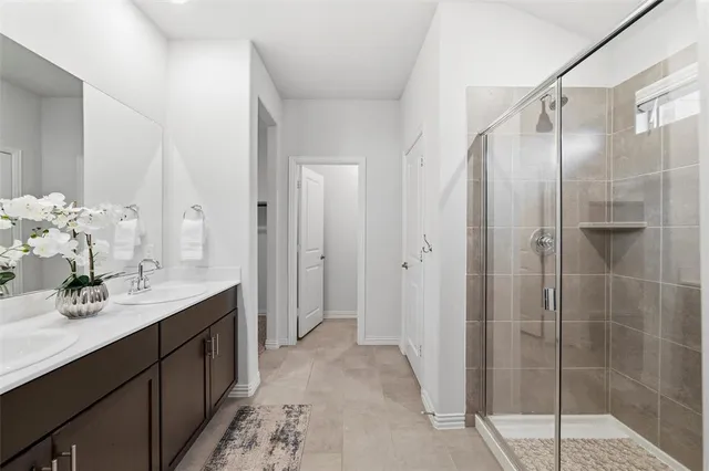 a bathroom with a glass shower door