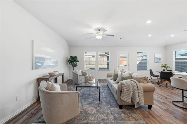 a living room with furniture potted plant and a window