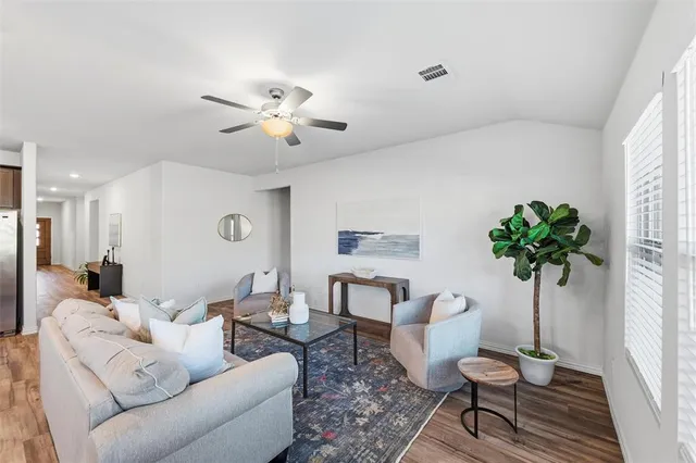 a living room with furniture and a potted plant