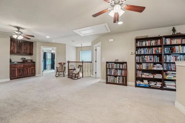 a view of a livingroom with furniture and a bookshelf