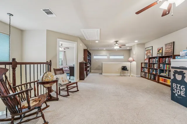 a view of a livingroom with furniture and a large window