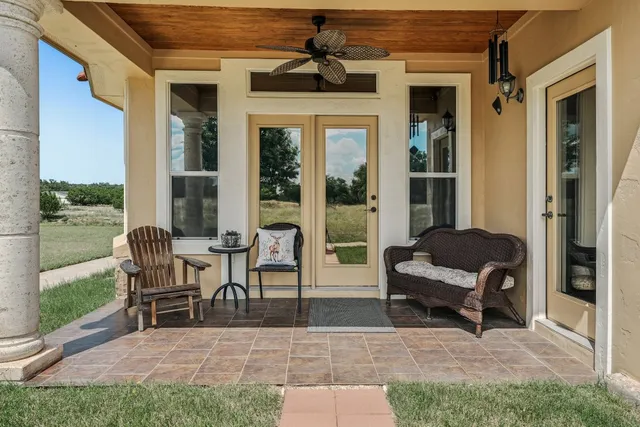 a view of a patio with chairs and a yard